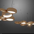 Modern Artistic Chandelier With Multiple Shiny Metal Rings And Warm Glowing Light
