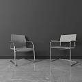 Two Modern Office Chairs With Metal Frame And Gray Design In Minimalist Workspace