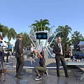 Outdoor VR Event Filming Scene With People Cameras Tripods Large Screen And Palm Trees