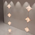 Modern Star Shaped Chandeliers Hanging In Minimalist Indoor Space With Soft Lighting