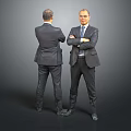 Two suited men one facing front with crossed arms and one behind against gray background