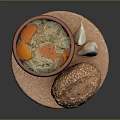 Hearty Soup With Carrots Noodles And Sesame Bread On Cork Mat With Garlic