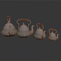 Set of Silver Teapots with Wooden Handles in Various Sizes Arranged Neatly