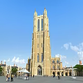 Historic European Architecture Tower With Stone Facade Plaza And People Under Blue Sky