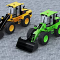 Yellow And Green Utility Vehicles With Large Buckets On Paved Ground