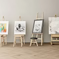 Wooden Art Easels Displaying Paintings On Light Colored Wall And Wooden Floor