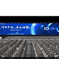 Large Event Venue With Blue Lighting Stage Backdrop Screen And Arranged Chairs