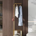 Golden Coat Rack With White And Light Blue Clothes And Pink Bag In Modern Interior