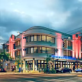 Art Deco Building Exterior With Curved Facade Large Windows Hotel Sign Palm Trees And Street Cars