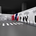 Person Standing By PVH Letters With White Brick Wall And Street Lamps Near Zebra Crossing