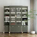 Elegant Green Bookcase With Gold Accents Glass Doors Books And Decorations Near Potted Plant