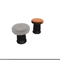Two modern stools with round white and brown upholstered seats and black cylindrical bases