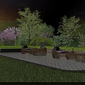 Outdoor Wicker Sofas On Patio With Green Lawn And Trees Against Sunset Sky