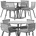 Round Wooden Table And Four Woven Chairs Set With Black Metal Frames And Gray Cushions