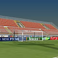 Football Stadium With Green Grass Pitch Red Seated Stands And Floodlights