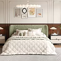 Modern Double Bed with Green Upholstered Headboard Quilted Bedspread Pillows Bedside Tables and Decorative Paintings