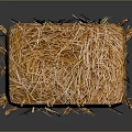 Brown Hay Bale Tied With Strings On Reflective Black Surface