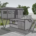 Two Story Container Building With Balcony White Railings And Staircase In Green Environment