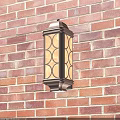 Decorative Outdoor Wall Sconce With Dark Frame White Lampshade On Red Brick Wall