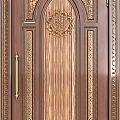 Luxurious Wooden Swing Door With Intricate Carvings And Gold Handles Design