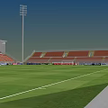 Football Stadium With Green Grass Pitch Red Seated Stands And Floodlights