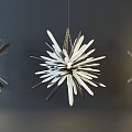 Unique Shaped Pendant Lights With Radiant Petal Like Structure Hanging On Dark Wall