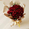Beautiful Red Roses Bouquet Wrapped In Brown Paper With Yellow Ribbon