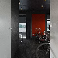 Public Office Space With Red Wall Black Furniture Computer Monitors Chalkboard Wall And Window View