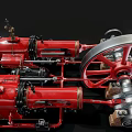 Red Steam Locomotive Model With Large Wheels And Mechanical Parts On Black Background