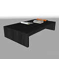 Modern Black Coffee Table With Sleek Design Stacked Books And Orange Decorative Items