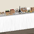 Assorted Desserts and Snacks on Long Table with White Tablecloth and Eiffel Tower Model