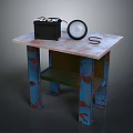 Worn Wooden Table With Blue Rusty Legs Black Box And White Round Object