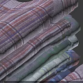 Folded Plaid Shirts Stacked With Various Colors On Dark Background