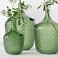 Green Textured Vases With Various Sizes Holding Green Foliage And White Small Flowers