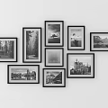 Stylish Black Framed Photo Wall With Irregular Arrangement And Black And White Landscape Building