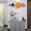 Orange Geometric Design Wall Clock With Grey Cabinet Green Plant Photo Frame And Decorative Items