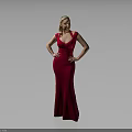 Woman in Red Long Dress Standing with Hands on Hips Against Gray Background