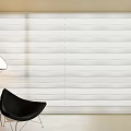 White Venetian Blinds Covering Wall in Modern Interior with Black Chair and Floor Lamp