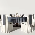 Elegant Dining Table Set With Round Tablecloth Chair Covers Cake And Wine Glasses