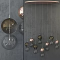 Modern Spherical Pendant Lights With Copper And Black Glass Balls Hanging On Gray Background