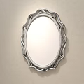 Oval Gold Framed Mirror Reflecting Bedroom Scene with Bed Nightstand Desk Chair and Striped Wall