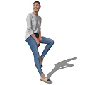 Smiling Woman in Light Gray Sweater and Blue Jeans with One Leg Raised and Shadow