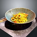 Yellow Noodles with Squid and Tomatoes in Textured Bowl and Chopsticks on Side