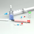 Medical Supplies Including Syringe Vial And Colorful Capsules On White Surface