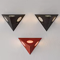 Triangular Black and Red Wall Lamps with Circular Cutouts Mounted on White Wall 3d model