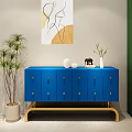Modern Blue Console Cabinet With Golden Handles Drawers Abstract Painting And Green Plants