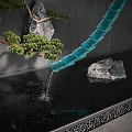 Water Fountain With Blue Curved Structure Flowing Water Rocks Pine Tree And Ripples