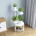 Multi Tiered Golden Plant Stand With Potted Greenery And White Planters In Living Room
