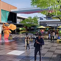 Modern Commercial Landscape With Pedestrian Walkway Starbucks McDonald's Green Plants And Sculpture