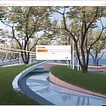Scenic Park Landscape With Curved Walkway Green Lawn Trees And Reflective Water